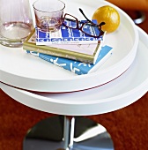 Books, glasses, spectacles and orange on side table