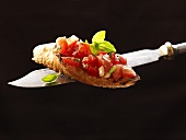 Bruschetta on a knife