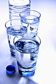 Three glasses of mineral water with bottle