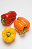 A red, a yellow and an orange pepper