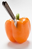Knife in orange pepper