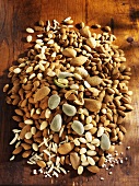 Shelled & unshelled almonds & slivered almonds on wooden background