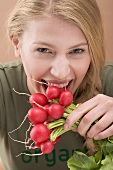 Woman biting a radish