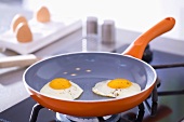 Two fried eggs in a frying pan