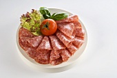 Sliced salami on plate