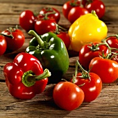 Fresh peppers and tomatoes on wooden background