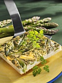 Piece of asparagus and chervil quiche on server