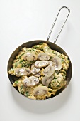 Omelette with mushrooms in frying pan
