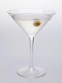 Martini with green olive in glass