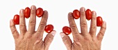Tomatoes between someone's fingers