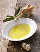 A dish of olive oil, a piece of bread and sea salt