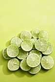Lime slices on green background