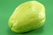 A chayote on a green background