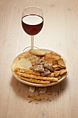 Small dish of nibbles and a glass of red wine