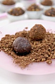Rolling chocolate truffles in toasted walnuts