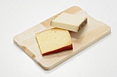 Two raw milk cheeses on wooden board