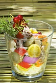 Seafood salad with vegetables and redcurrants in glass