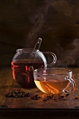 Cup of yellow fruit tea and pot of red fruit tea