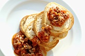 Toasted baguette slices with Bolognese sauce