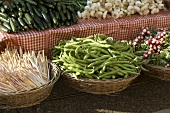 Vegetables on stall and in baskets at a market