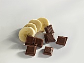 Several pieces of chocolate and slices of banana