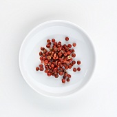 A plate of pink pepper, seen from above