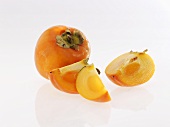 Persimmons, whole and sliced