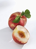 White-flesh peaches, whole and halved