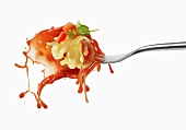 Pasta and squirted tomato sauce on a fork