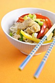 Stir-fried chicken and vegetables on noodles
