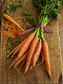Bunch of baby carrots on wooden board