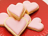 Pink heart-shaped biscuits on plate