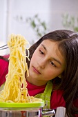 Girl with cooked spaghetti