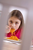 Girl eating spaghetti bolognese