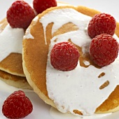 Pancakes with cream and fresh raspberries