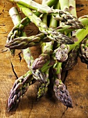 Green asparagus spears on wooden background