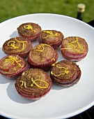 Barbecued, marinated red onions on a plate