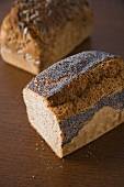 Two tin loaves, one with sunflowers and one with poppy seeds