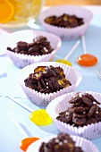 Chocolate crispies in paper cases and lollipops