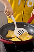 Frying French toast in a frying pan
