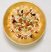 Dried fruit and nuts in golden dish