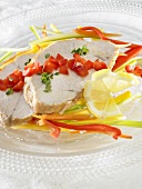 Roast turkey on root vegetables with red pepper and lemon