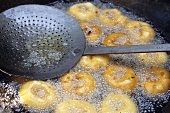 Indian lentil fritters being deep-fried
