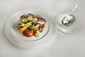 Grilled vegetables and pork with baked potato