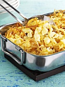Cheese spaetzle noodles with fried onions in a roasting tin