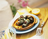 Stuffed vine leaves with lemon wedges