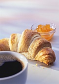 A croissant, marmalade and a cup of coffee