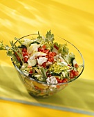 Mixed salad with sheep's cheese in glass bowl