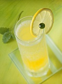 A cocktail with a slice of lemon