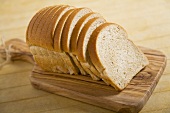 Loaf of Sliced Wheat Bread on Cutting Board